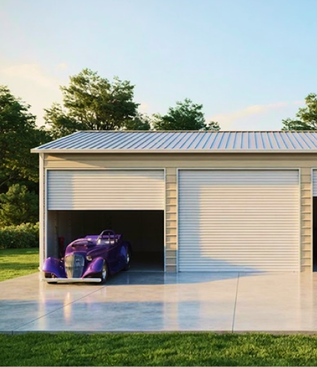 Metal garage with the door open on a finished concrete driveway