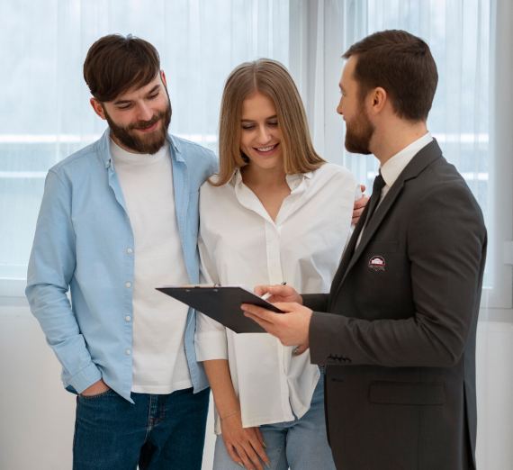 Couple reviewing rent-to-own paperwork with an advisor