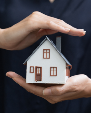 Specialist holding a model house