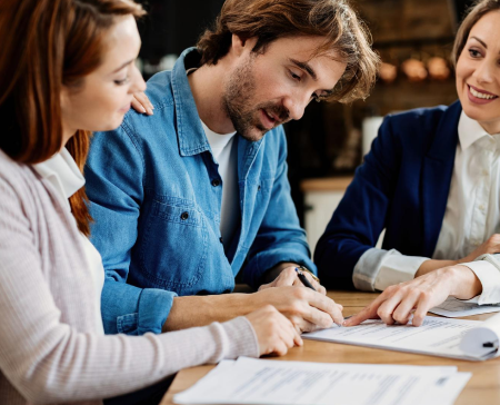 Couple going through financing paperwork with a specialist